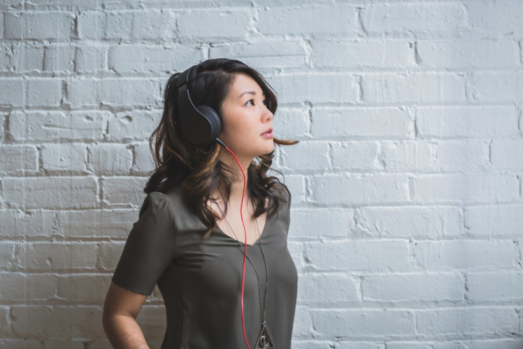 Image of a young woman listening to music with headphones