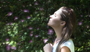 Woman outside smelling flowers