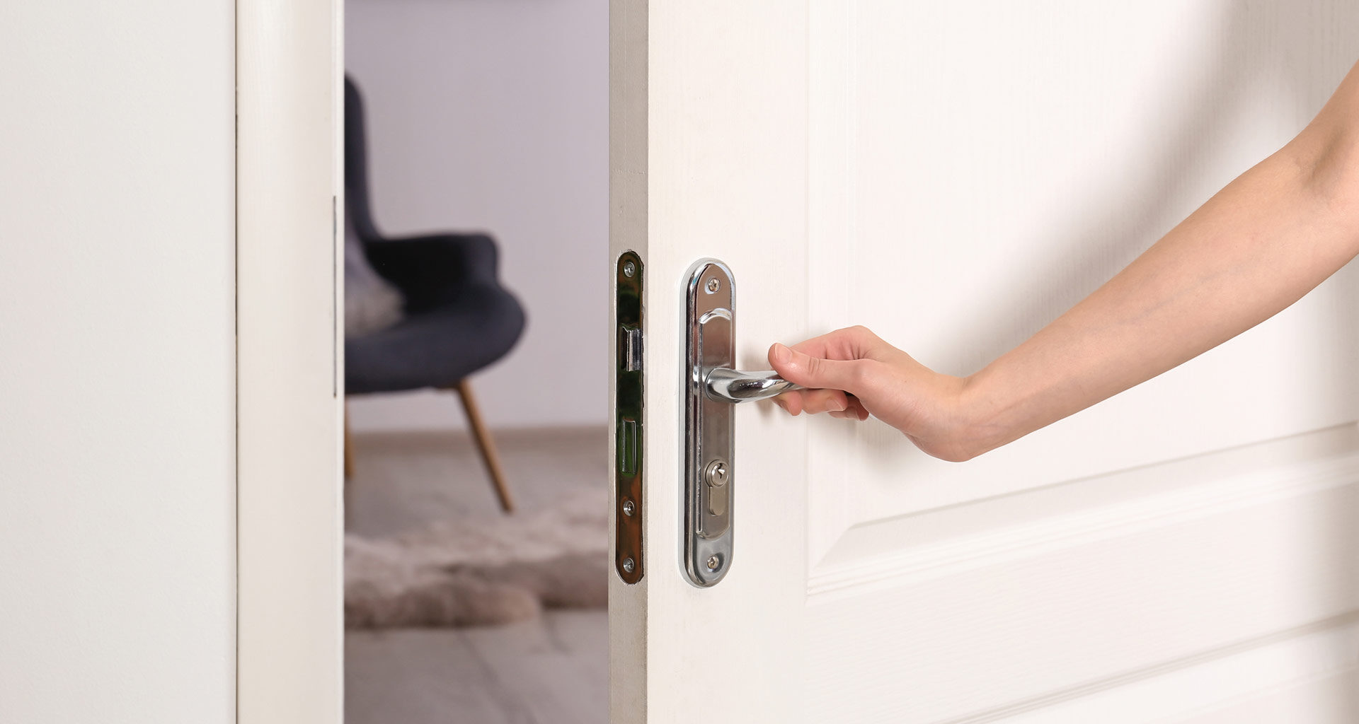 Photo of a hand opening a door