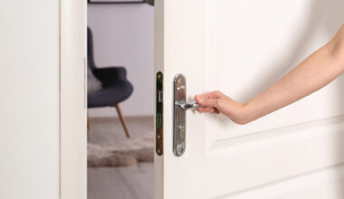 Photo of a hand opening a door